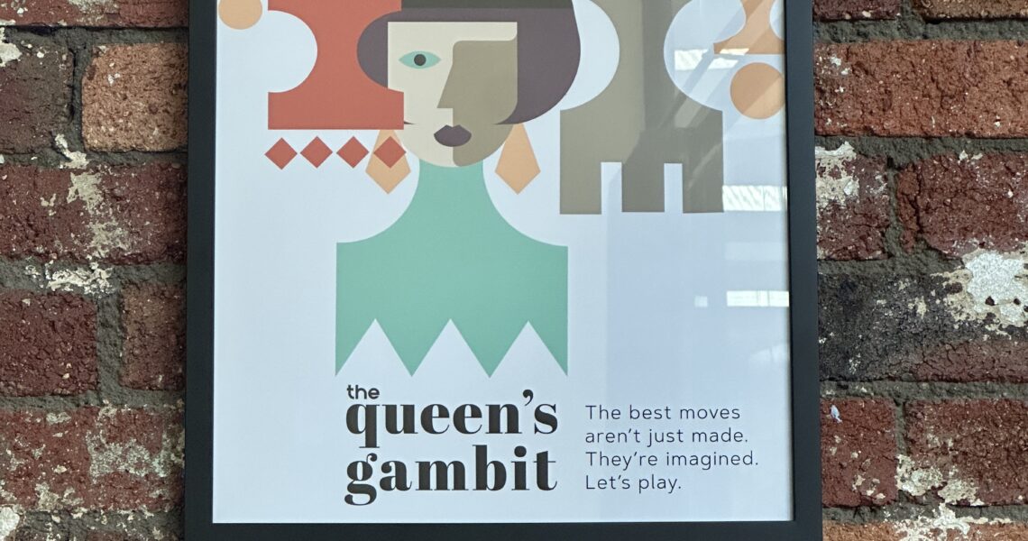 Framed Queen’s Gambit artwork on exposed brick wall in South Melbourne coworking meeting room. ko&co workhub
