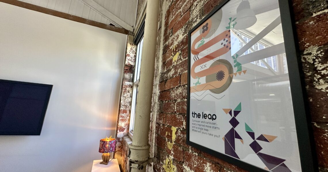 Framed ko&co workhub artwork titled "The Leap" on exposed brick wall in meeting room (The Leap Room) for hire in South Melbourne