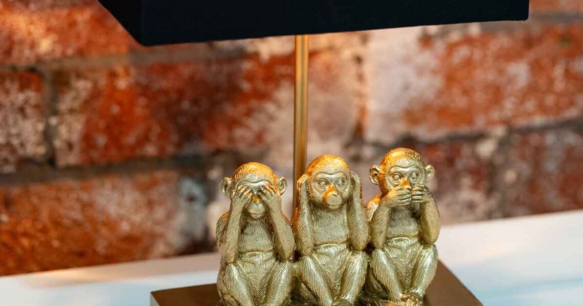 Close-up of the gold “see no evil, hear no evil, speak no evil” monkey lamp in ko&co workhub’s Looking Glass meeting room. South melbourne coworking and shared office space for small business