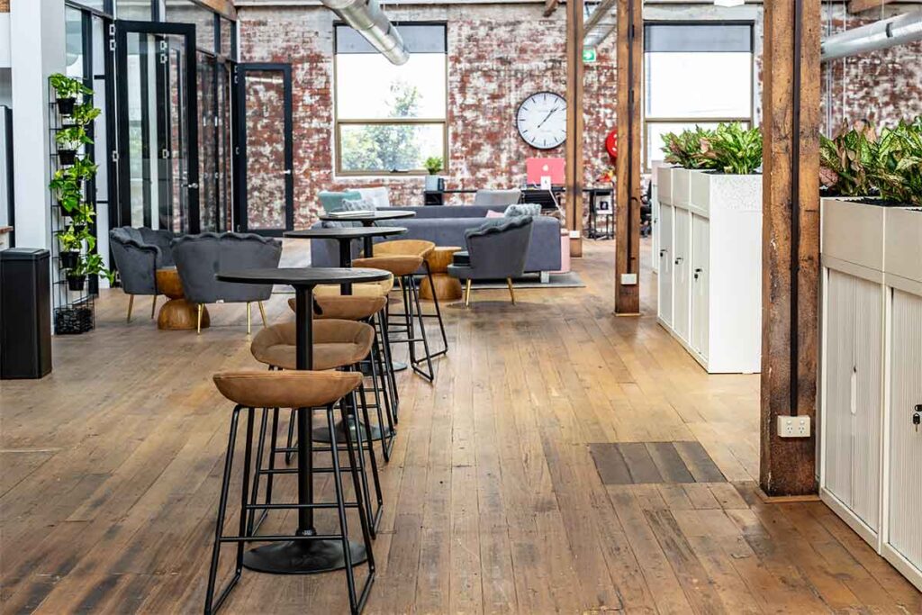 Bar-height tables and chairs in the shared area at ko&co workhub South Melbourne, ideal for casual catch-ups or event seating