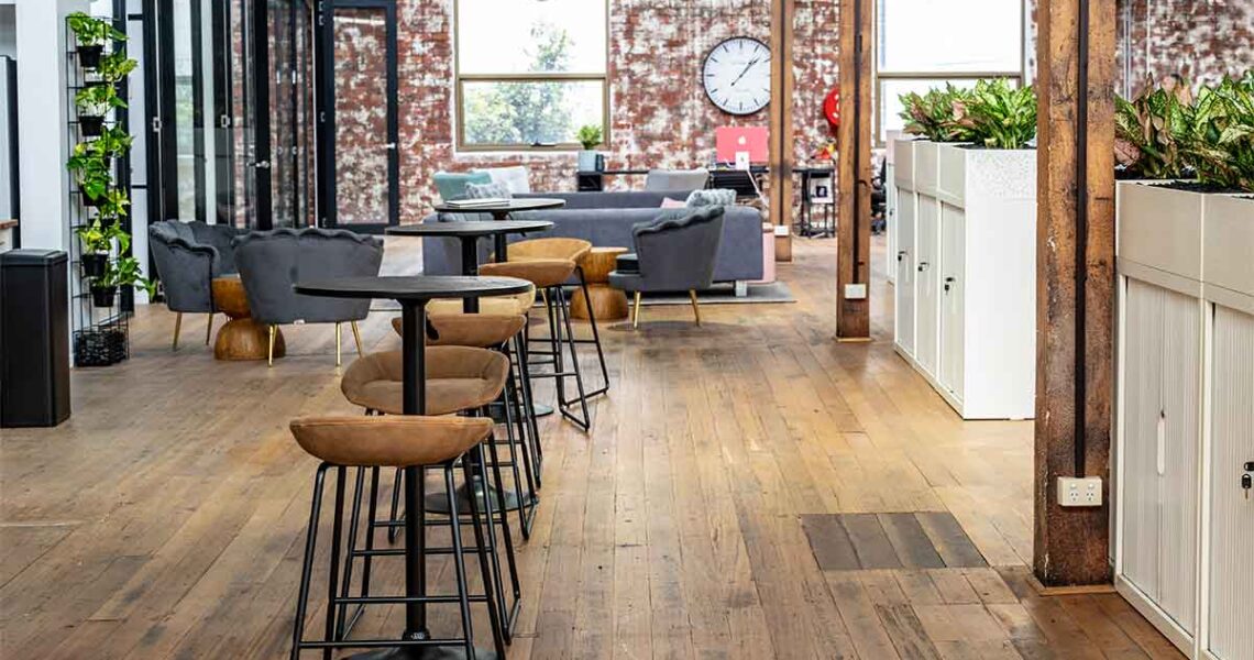 Bar-height tables and chairs in the shared area at ko&co workhub South Melbourne, ideal for casual catch-ups or event seating