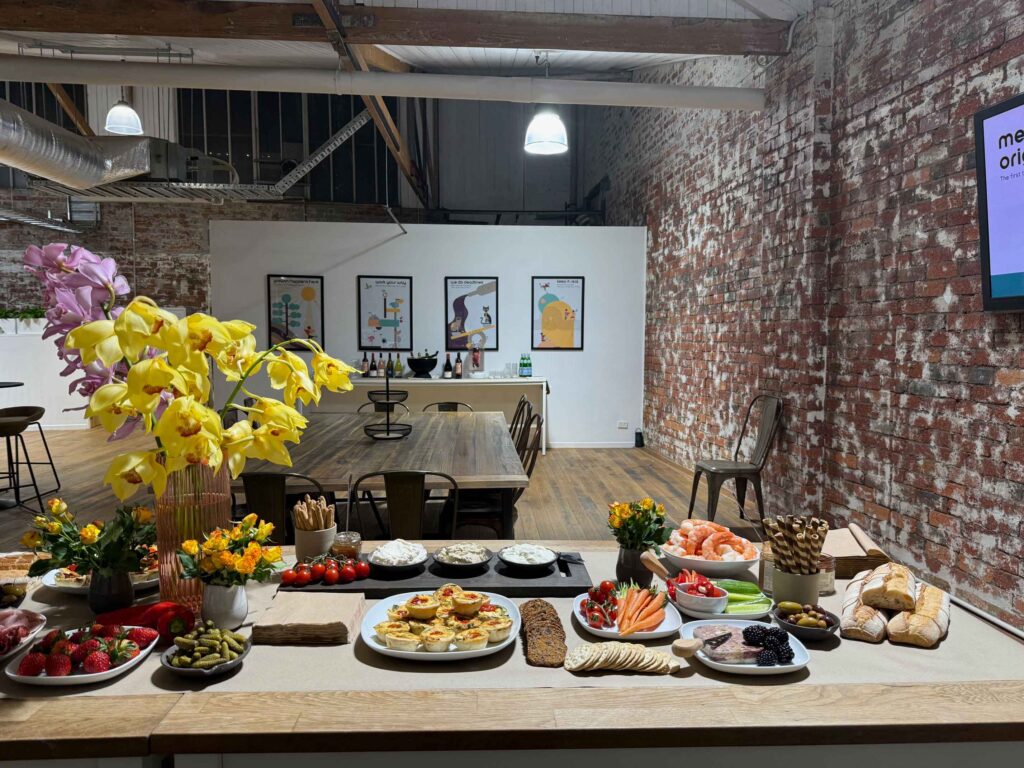 Grazing table at ko&co workhub launch night with digitally illustrated brand artwork in the background