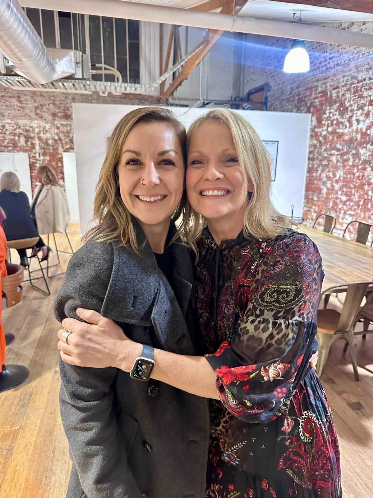 Kendra hugging Erin, founder of Hustle Tribe Gym and Retreats, at the ko&co workhub launch event in South Melbourne