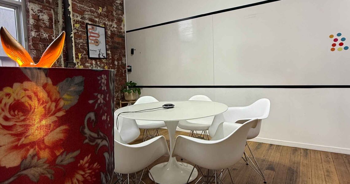 A boutique six-person meeting room at ko&co workhub with a TV screen, natural light, and thoughtful touches.