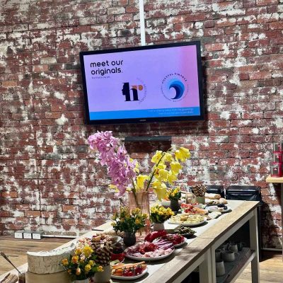 ko&co workhub launch grazing table with The Originals logos—Head Recruitment and Coastal Finance—displayed on screen